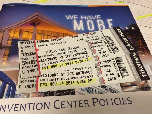 Three ice skating tickets for an event at the MS Coast Coliseum, with a convention center policies document in the background.