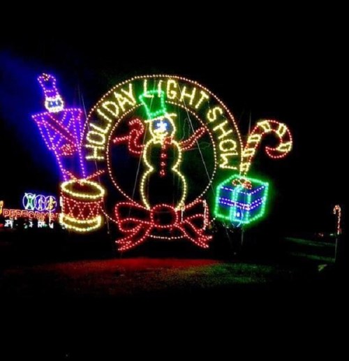 Colorful holiday lights display featuring a snowman, candy cane, gift, and festive decorations.