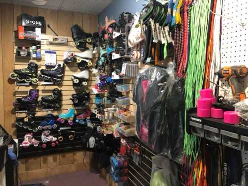 A shop interior displaying various roller skates, accessories, and colorful gear on shelves and walls.