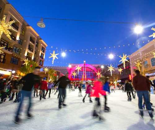 A lively ice skating rink decorated with festive lights and stars, surrounded by people enjoying the winter evening.