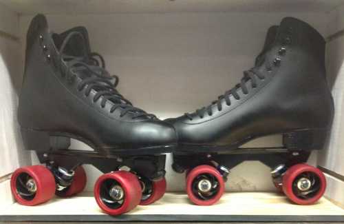 A pair of black roller skates with red wheels, displayed side by side in a box.