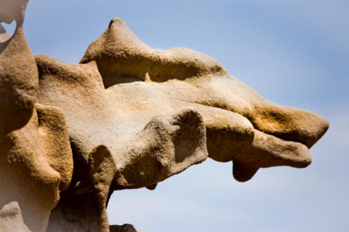 Close-up of a uniquely shaped rock formation against a clear blue sky.