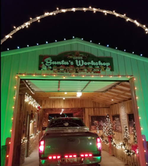 A festive entrance to Santa's Workshop, adorned with colorful lights and holiday decorations.
