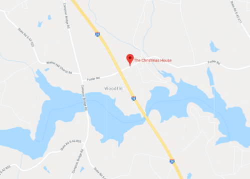 Map showing the location of "The Christmas House" near Woodfin, with nearby roads and water features.