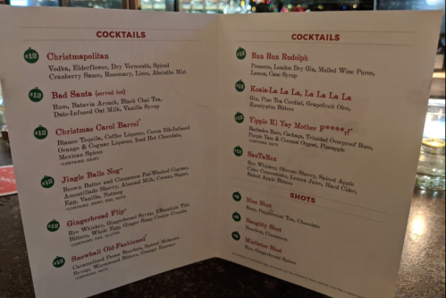 Cocktail menu featuring drinks like Christmapolitan, Bad Santa, and Jingle Balls Nog, with ingredients listed.