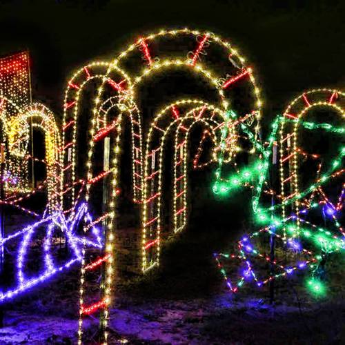 Colorful holiday lights arranged in arch shapes against a dark background, creating a festive atmosphere.