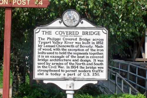 Sign detailing the history of the Philippi Covered Bridge, built in 1852, highlighting its architectural significance.