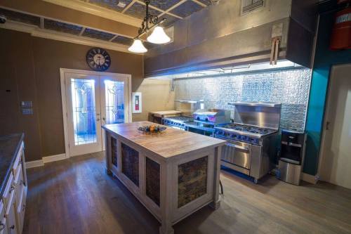 A modern kitchen featuring a large island, stainless steel appliances, and a stylish backsplash.