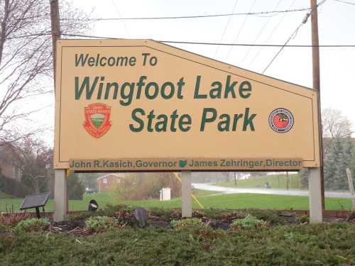 Welcome sign for Wingfoot Lake State Park, featuring the Ohio state emblem and names of officials.