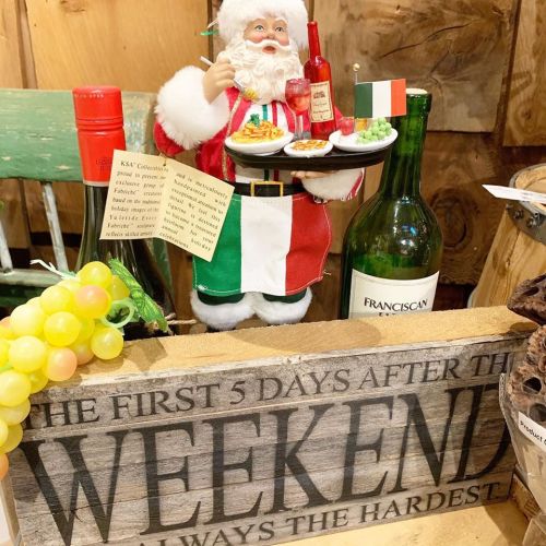 A festive Santa figurine in a red and white outfit holds drinks and snacks, with a sign reading "The first 5 days after the weekend..."