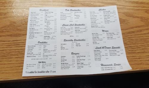 Menu featuring breakfast, sandwiches, chicken, wraps, burgers, sides, and homemade soups with prices listed.