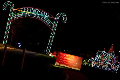 Colorful holiday lights form an archway and display a festive house, promoting a Christmas radio station.