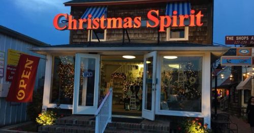 A festive store named "Christmas Spirit" with bright signage and holiday decorations, warmly inviting customers inside.