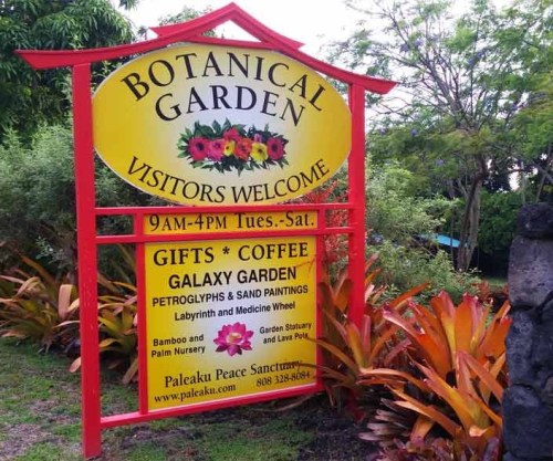 Sign for a botanical garden featuring hours, gifts, coffee, and attractions like a galaxy garden and petroglyphs.