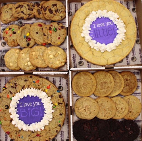 A variety of cookies arranged in boxes, featuring two large cookies with messages: "I love you BIG!" and "I love you little!"