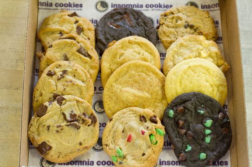 A box of assorted cookies, including chocolate chip, peanut butter, and mint chocolate, arranged neatly.