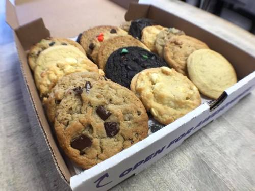 A box of assorted cookies, including chocolate chip, oatmeal, and sugar cookies, arranged neatly inside.