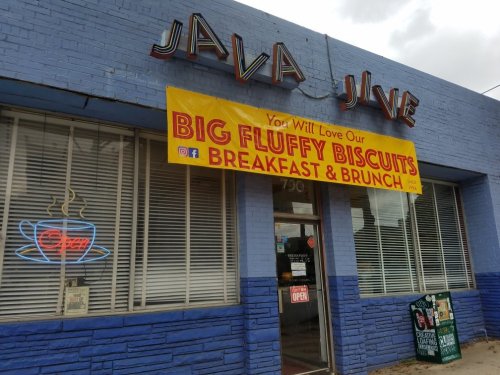 Exterior of Java Jive café with a large banner advertising "Big Fluffy Biscuits" and open sign in the window.