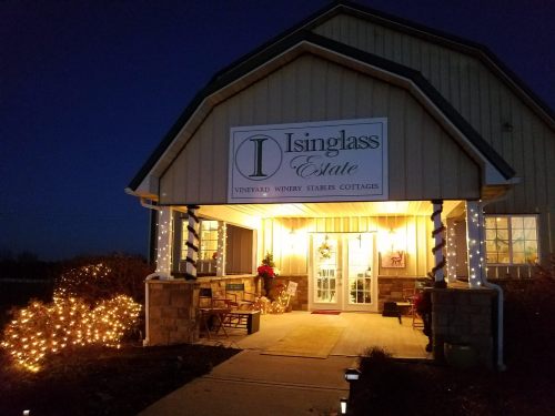 A cozy winery entrance at night, adorned with lights and festive decorations, welcoming visitors to Isinglass Estate.