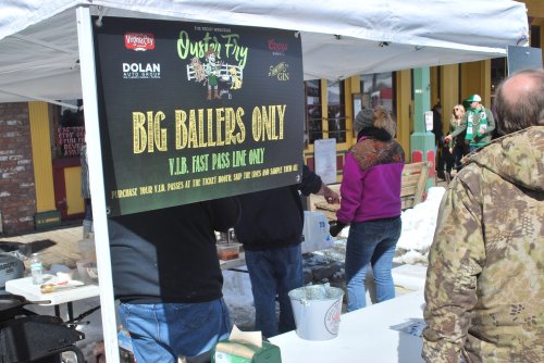 A vendor booth with a sign reading "Big Ballers Only" for VIP fast pass line, set up at an outdoor event.