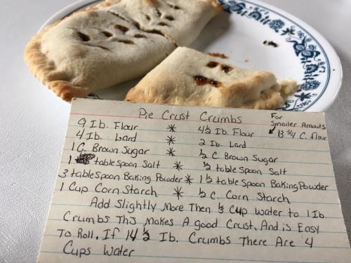 A plate with pie crust crumbs and a recipe for pie crust, including ingredients and measurements.