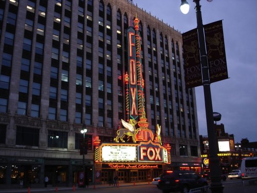 The illuminated Fox Theatre marquee at dusk, showcasing vibrant neon lights and classic architecture.