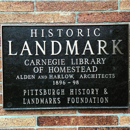 Plaque marking the Carnegie Library of Homestead as a historic landmark, detailing architects and dates.