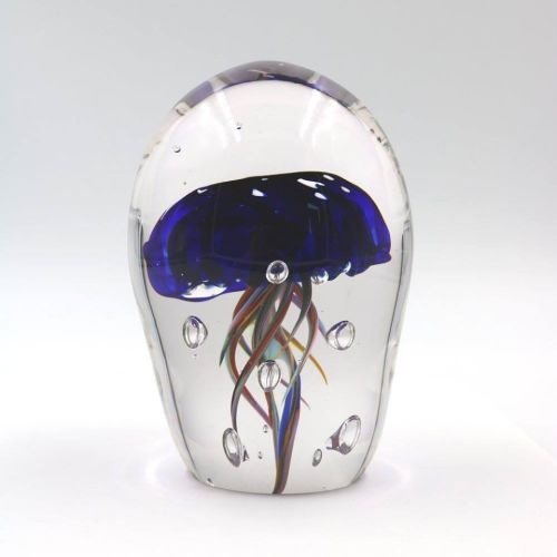 A glass sculpture of a jellyfish with a blue dome and colorful tentacles, encased in a clear, rounded shape.