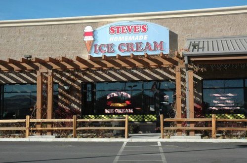 Exterior of Steve's Homemade Ice Cream shop, featuring a sign with an ice cream cone and a wooden pergola.