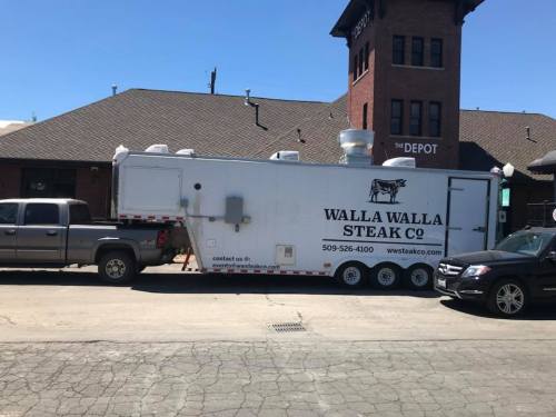 A food truck labeled "Walla Walla Steak Co" parked beside a building with a sign reading "The Depot."