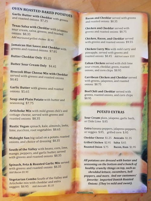 Menu featuring baked potato options with various toppings, including cheese, sauces, and extras. Prices listed.