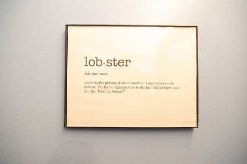 A framed definition of "lobster," describing it as a term for a lifelong partner, referencing lobsters' mating habits.
