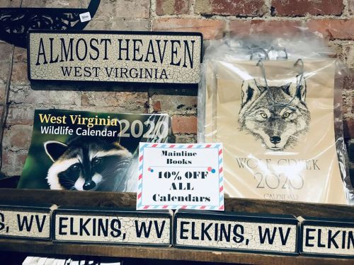 Display of calendars and a sign offering 10% off all calendars at Mainline Books in Elkins, West Virginia.
