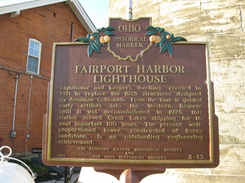 Historical marker for Fairport Harbor Lighthouse, detailing its history and significance in Great Lakes shipping.