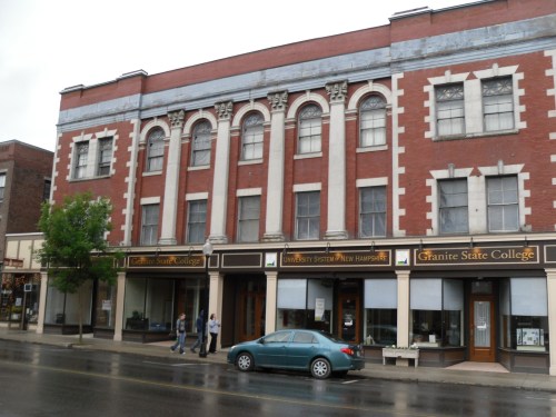 Historic brick building with arched windows, featuring signs for Granite State College and University System of New Hampshire.
