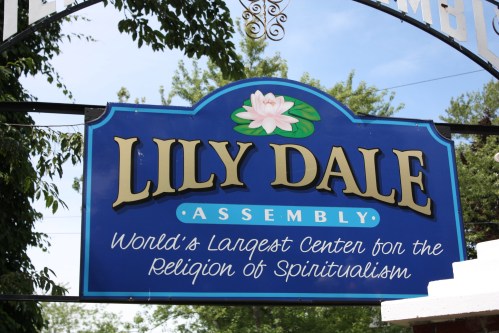 Sign for Lily Dale Assembly, the world's largest center for the religion of Spiritualism, featuring a lotus flower design.