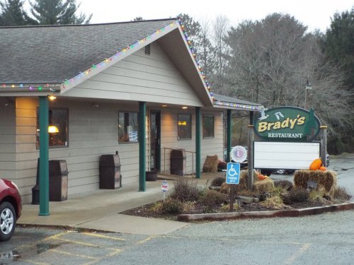 Exterior of Brady's Restaurant, featuring holiday lights, a sign, and a welcoming entrance with seasonal decorations.