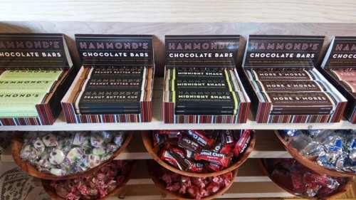 A display of Hammond's chocolate bars in various flavors, with bowls of assorted candies below.