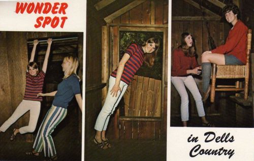 Three women posing playfully in a wooden cabin, showcasing fun activities at Wonder Spot in Dells Country.