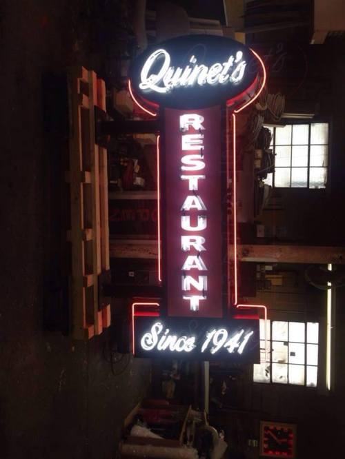 Neon sign for Quinet's Restaurant, featuring the name and "Since 1941" in bright lettering.