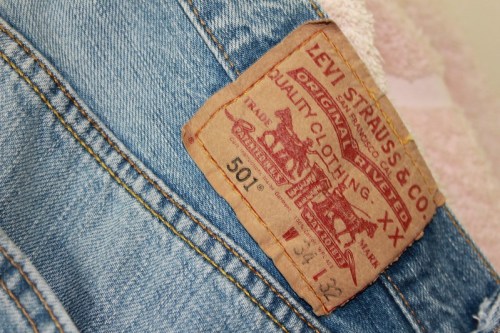 Close-up of a Levi Strauss & Co. label on a pair of denim jeans, featuring the iconic 501 style and vintage design.