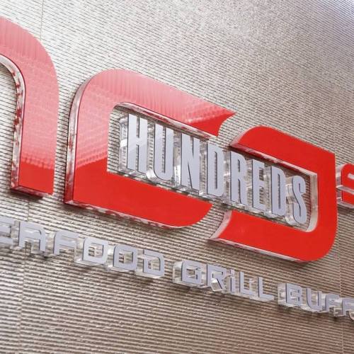 Sign for "Hundreds Seafood Grill Buffet" with a modern design and bold red lettering.