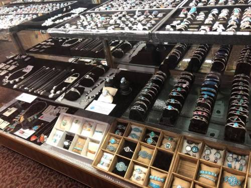 A display case filled with various jewelry pieces, including rings, bracelets, and necklaces, showcasing intricate designs.