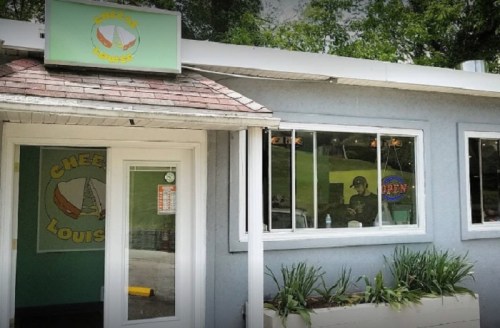 Exterior of a casual eatery with a sign reading "Cheese Louise," featuring a green and white color scheme.