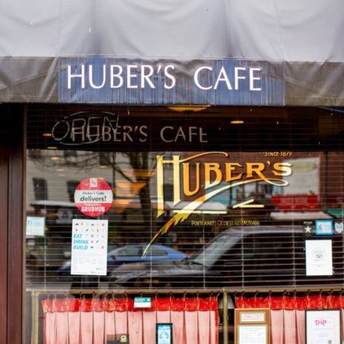 Signage of Huber's Cafe, Portland's oldest restaurant, with "Open" displayed in the window.
