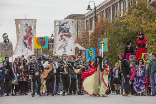 A vibrant parade featuring musicians, dancers, and colorful banners, celebrating cultural traditions in a festive atmosphere.