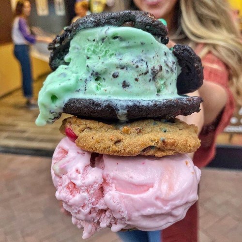 A stack of colorful ice cream sandwiches with mint chocolate chip and strawberry ice cream between cookies.