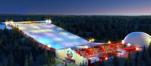 Aerial view of a winter sports facility with illuminated slopes and a large dome, surrounded by trees at night.