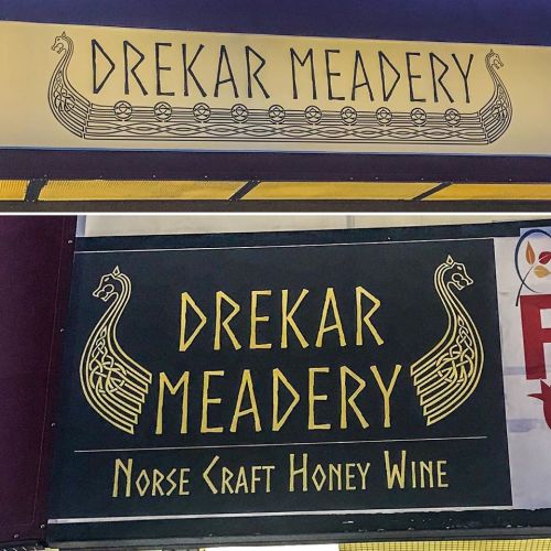 Two signs for Drekar Meadery featuring Norse designs and text promoting honey wine.