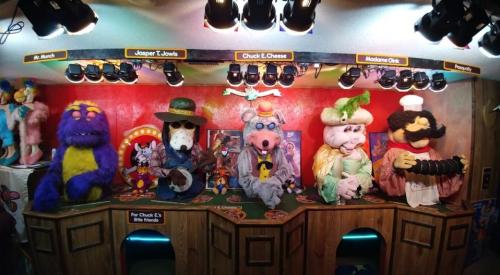 A colorful display of animatronic characters from a children's entertainment venue, featuring various whimsical costumes.